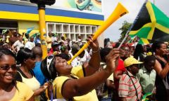 Jamaicans celebrate their country's clean sweep in the Olympic 200m final